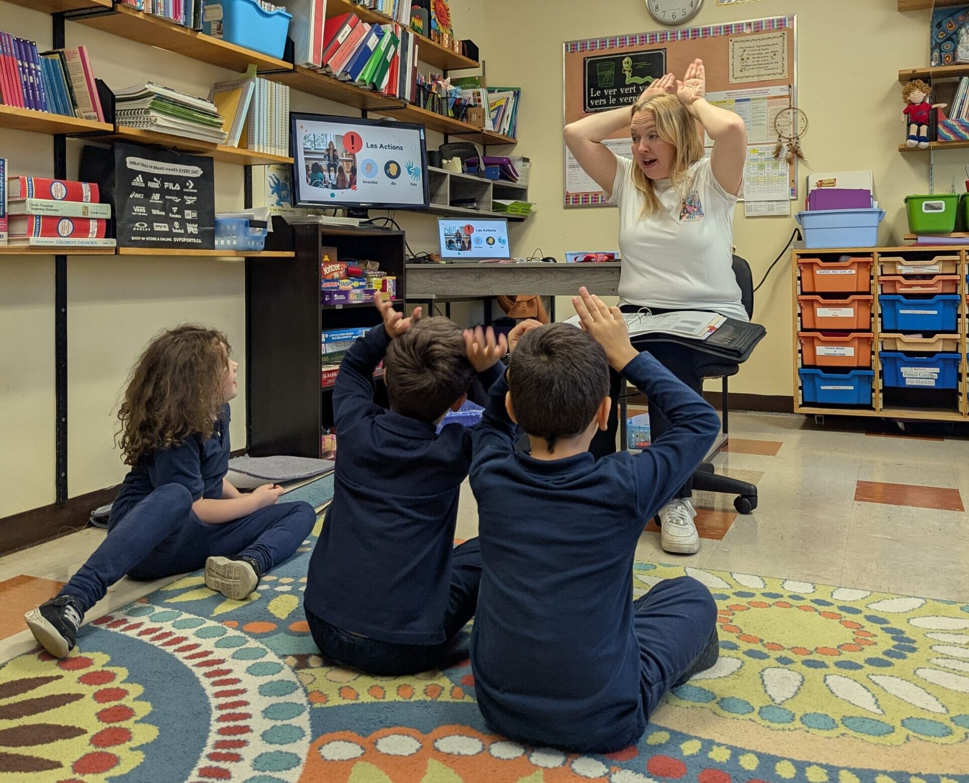 In French class the students are taught using the AIM method, where each word is taught using a hand gesture, so that the students are speaking, hearing and feeling the language as they learn.